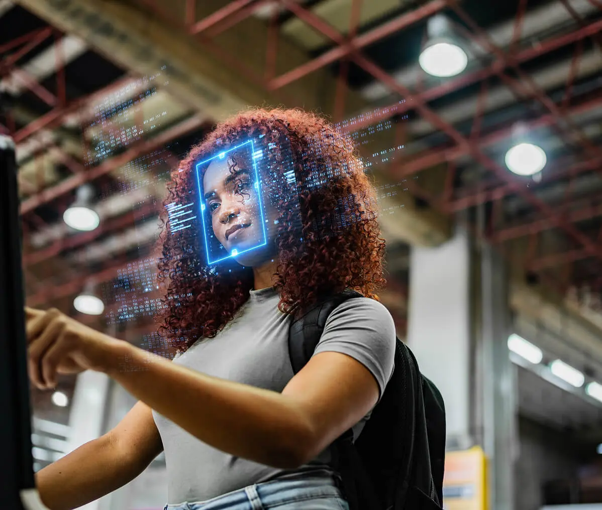 Woman interacting with facial recognition screen
