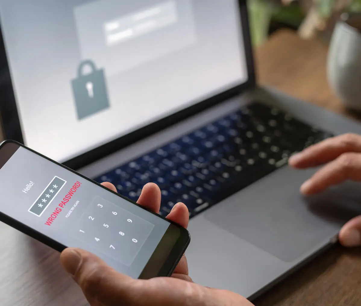 Phone with incorrect password next to laptop