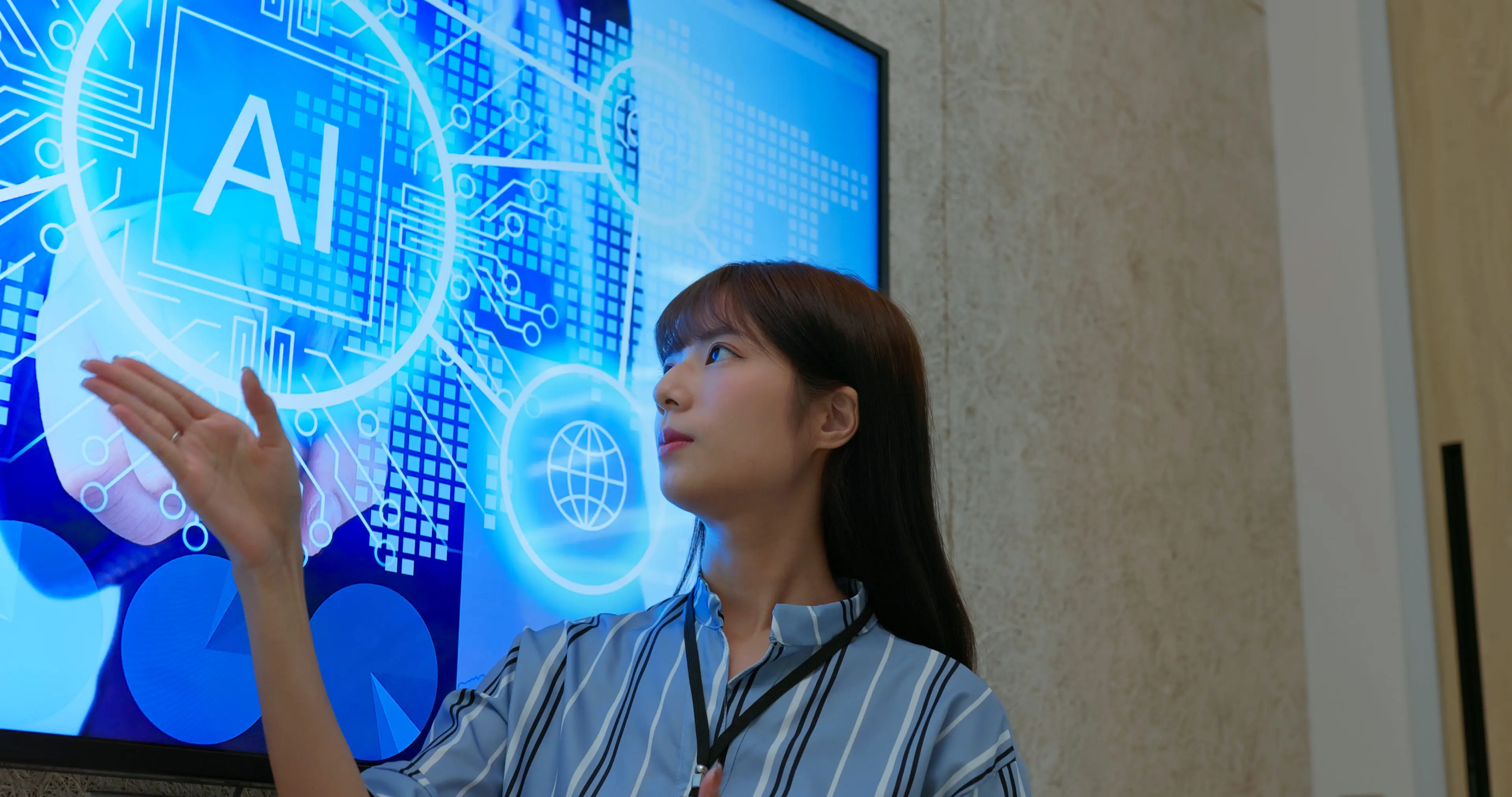 A woman looking thoughtfully at a digital screen with blue holographic data.