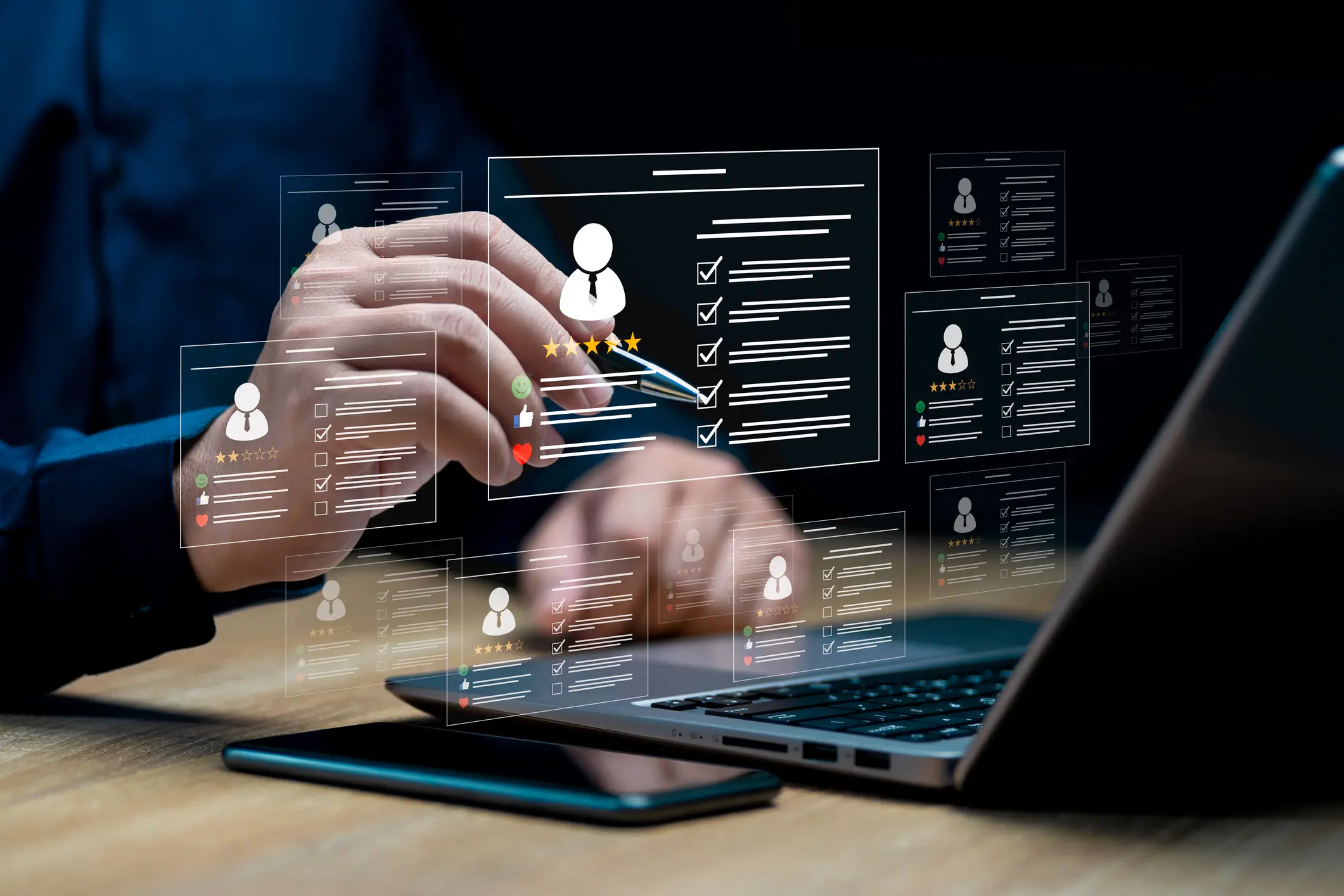 A person interacts with a laptop displaying digital human resource icons and data.