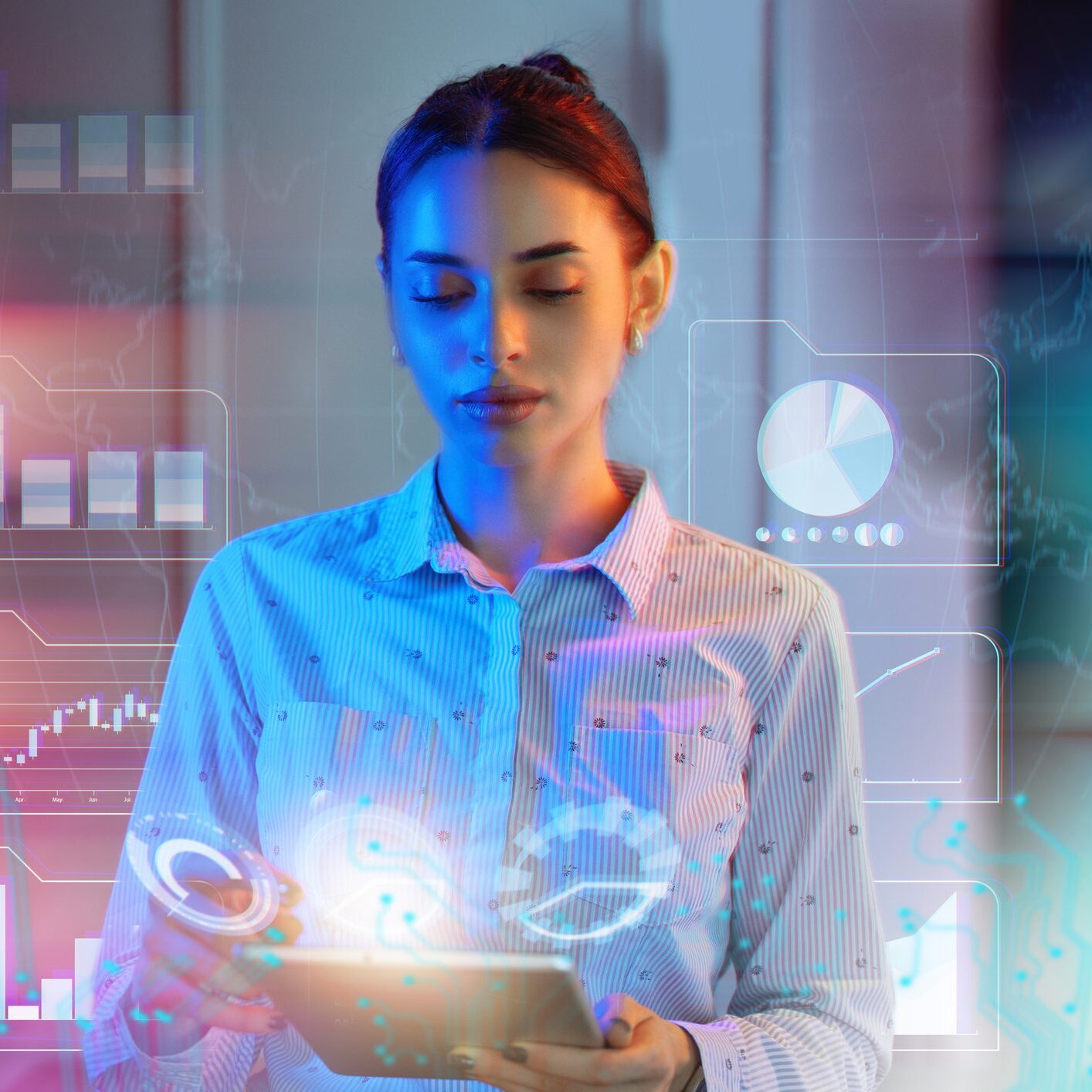 A woman using a tablet with futuristic digital holograms around her.