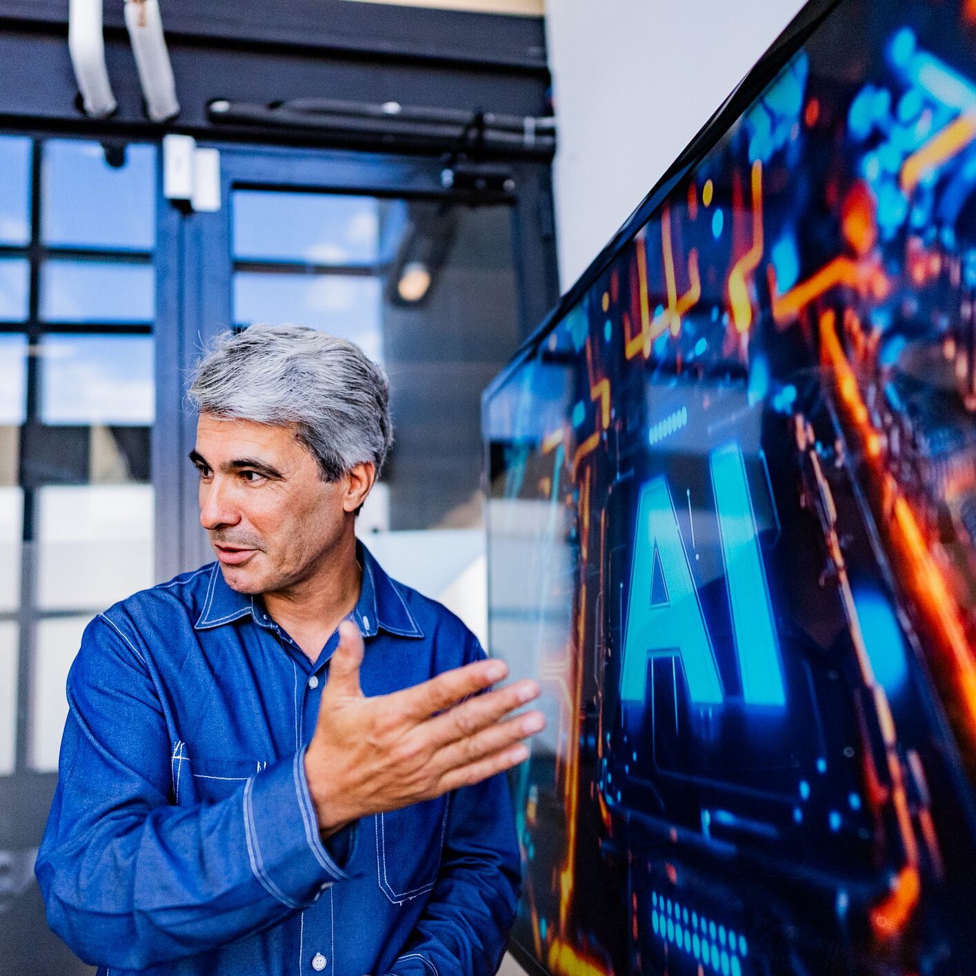 Man explaining AI concepts in a modern tech setting.